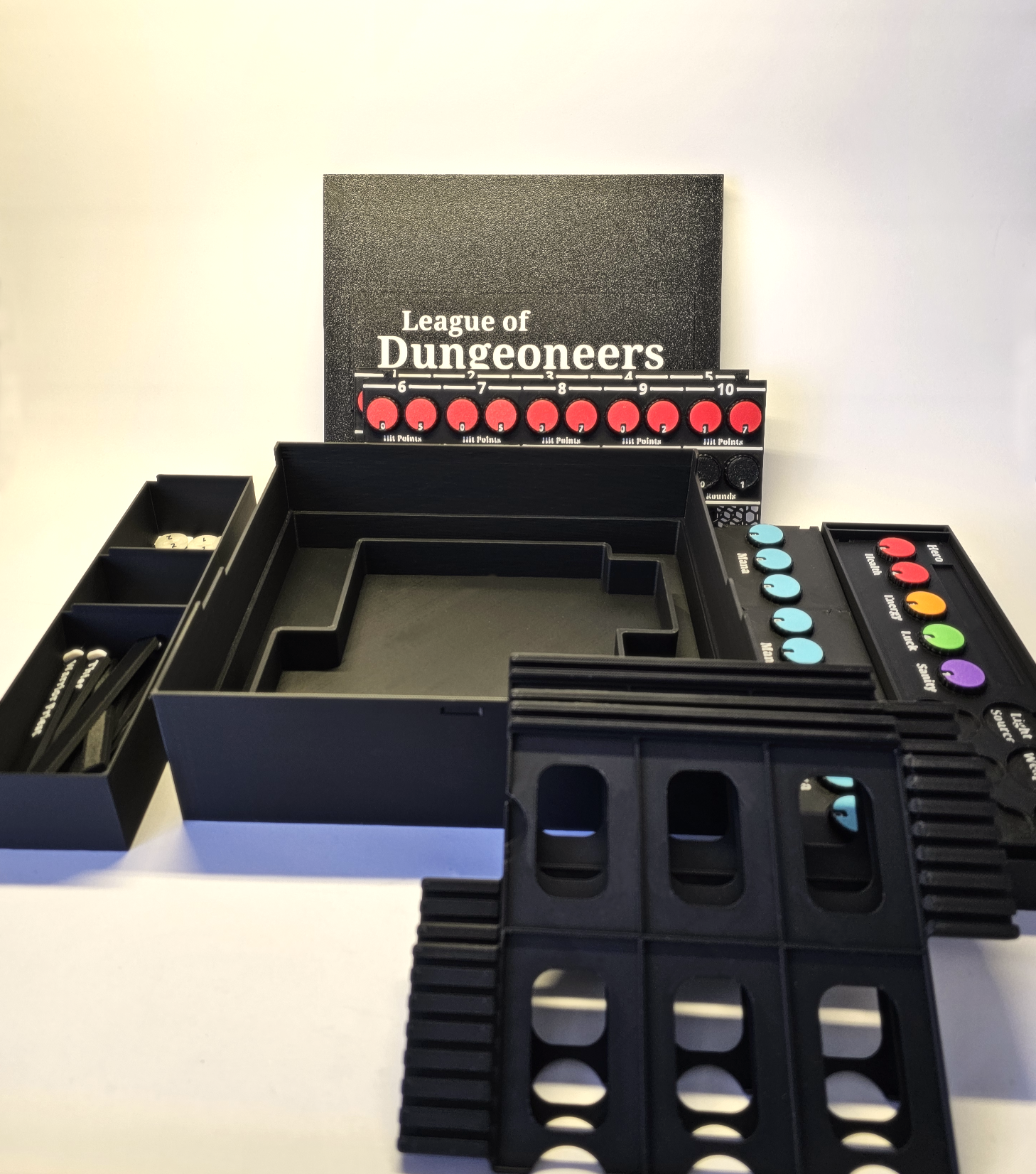 Deluxe board game accessories including a board, and pieces for the 'League of Dungeoneers' board game.